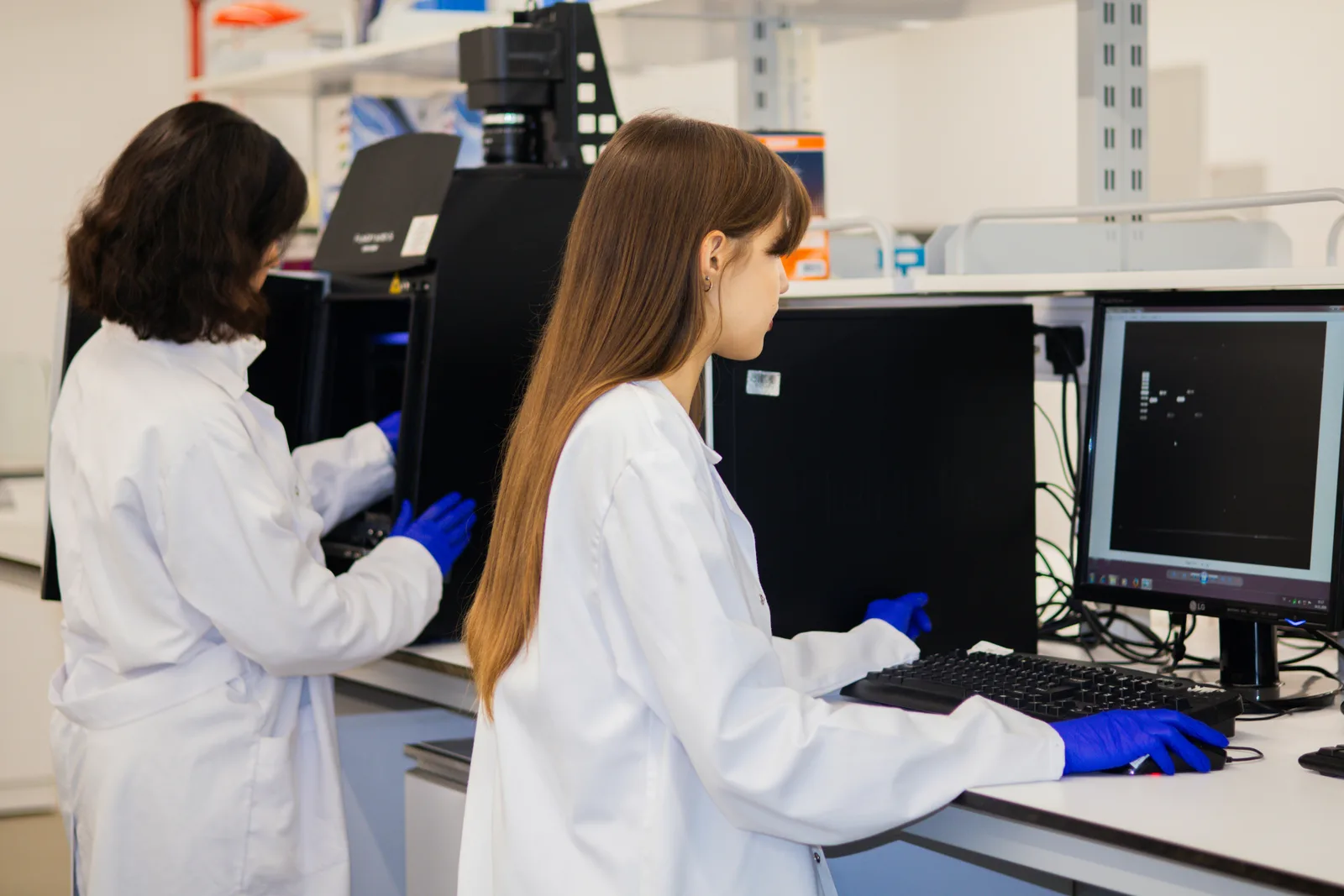 Researchers working in a laboratory with medical imaging equipment