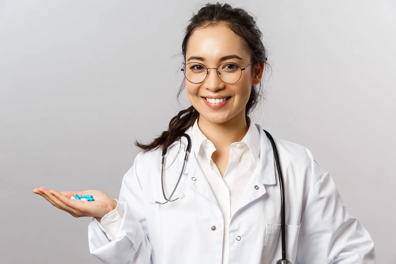 Doctor holding medication tablets