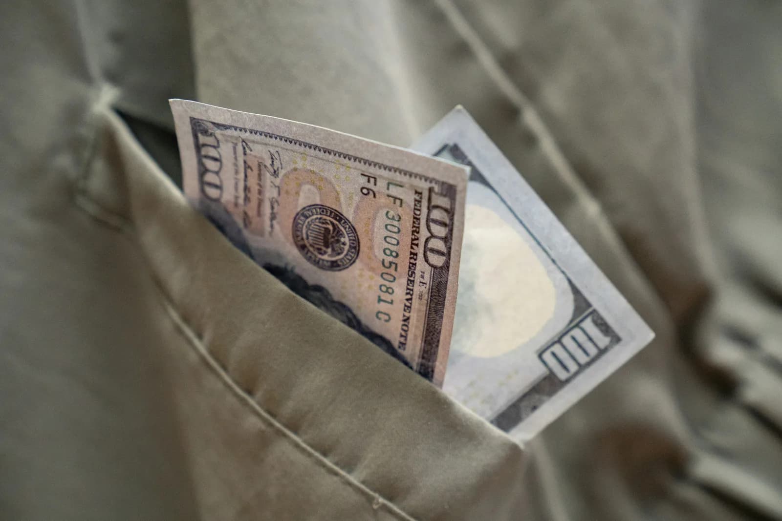 Dollar bill extending from a pocket