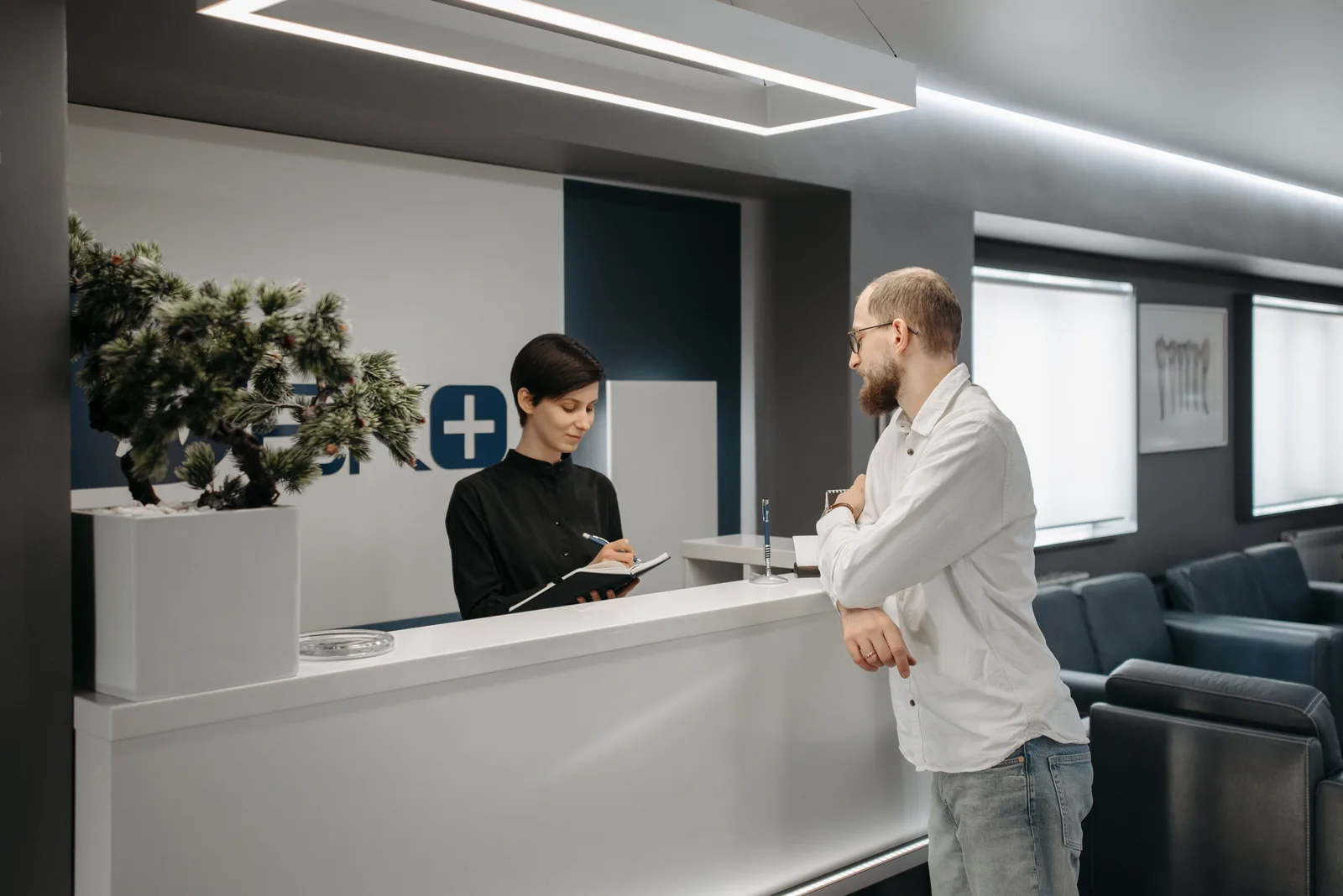 Patient speaking with a healthcare office receptionist