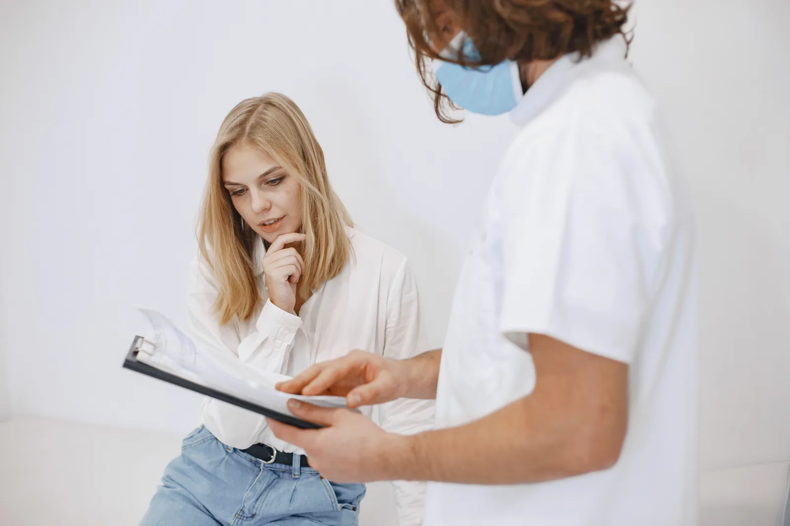 Doctor and patient reviewing medical information on a clipboard
